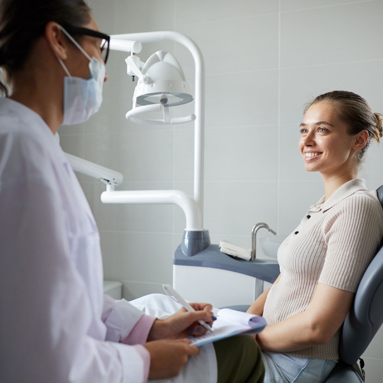 Dentist explaining woman patient